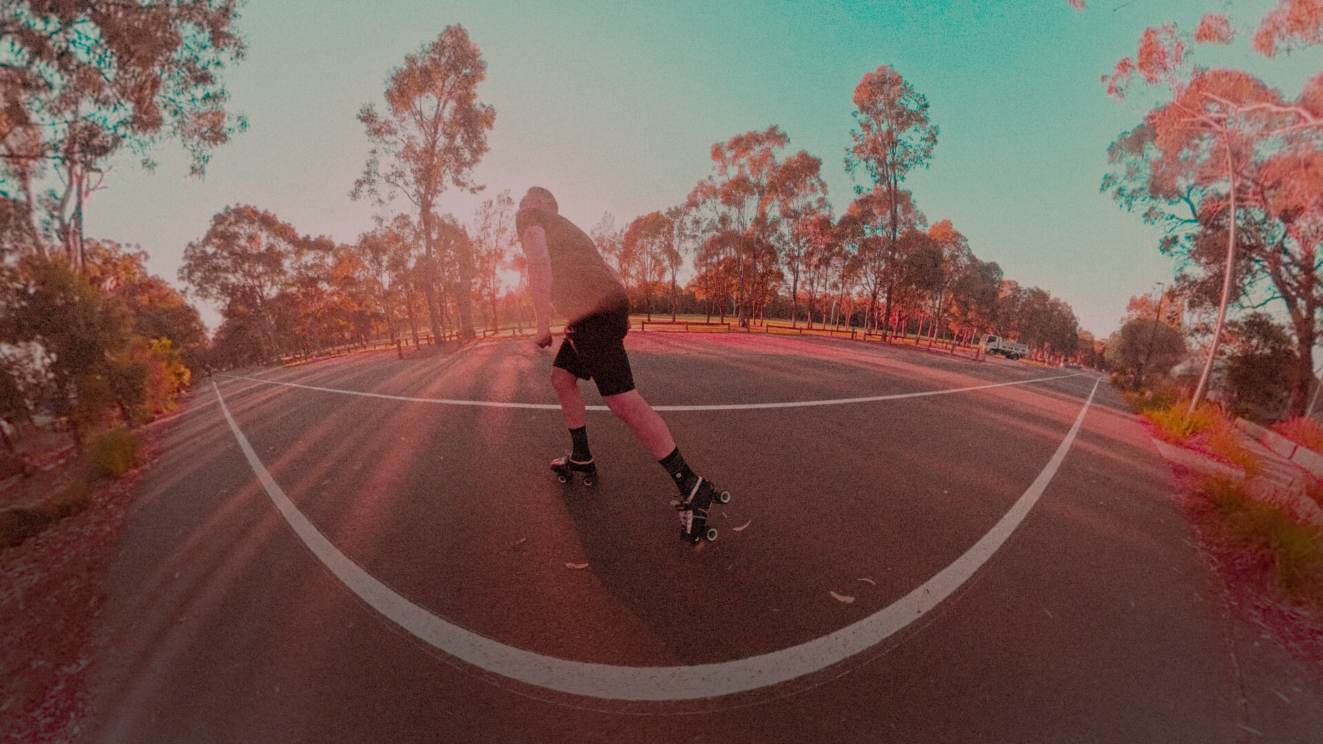 A roller skater skating around Parramatta Park at golden hour
